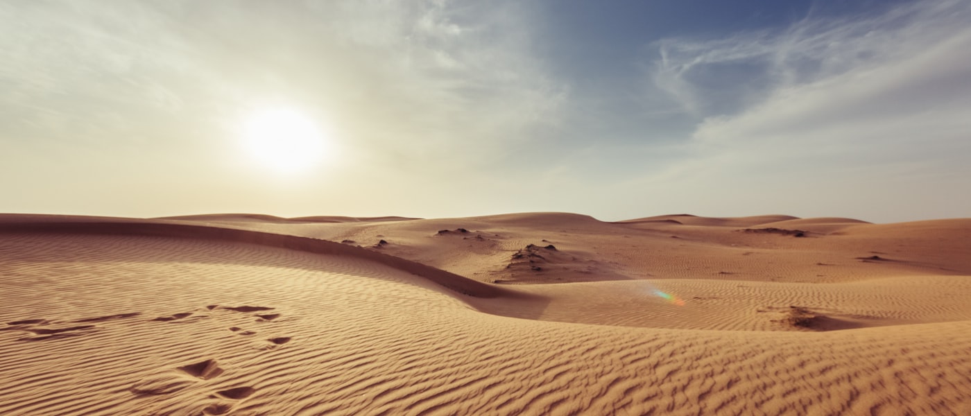 Golden sand dunes with light and shadow patterns